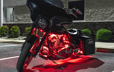 Touring motorcycle lit up with red LED accent lighting